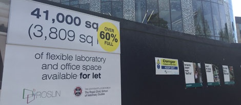 photo of hoarding with signage during the development phase of Roslin Innovation Centre 