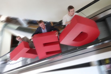 Photo of TED letters on escalator carried by Neil Brownlee, Head of Business Events, VisitScotland; Marshall Dallas, Chief Executive, EICC and Amanda Ferguson, Head of Business Tourism at Marketing Edinburgh - image credit Visit Scotland