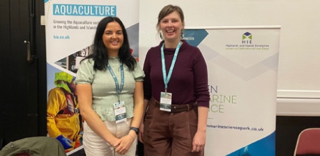 representatives from Highlands & Islands Enterprise standing at exhibition stand at SSIA 2025 conference